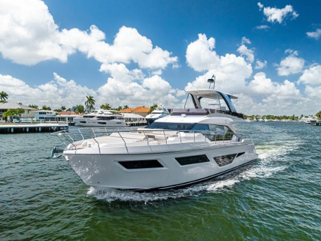 Motor yacht cruising along the South Florida Intracoastal Waterway, representing marine air conditioning and chiller service for onboard cabins and living areas.